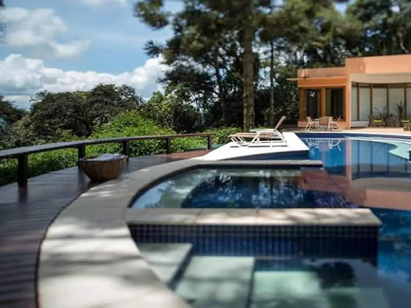 Piscina do Kuriuwa com HidroSPA aquecida no centro e vista para as montanhas de Monte Verde